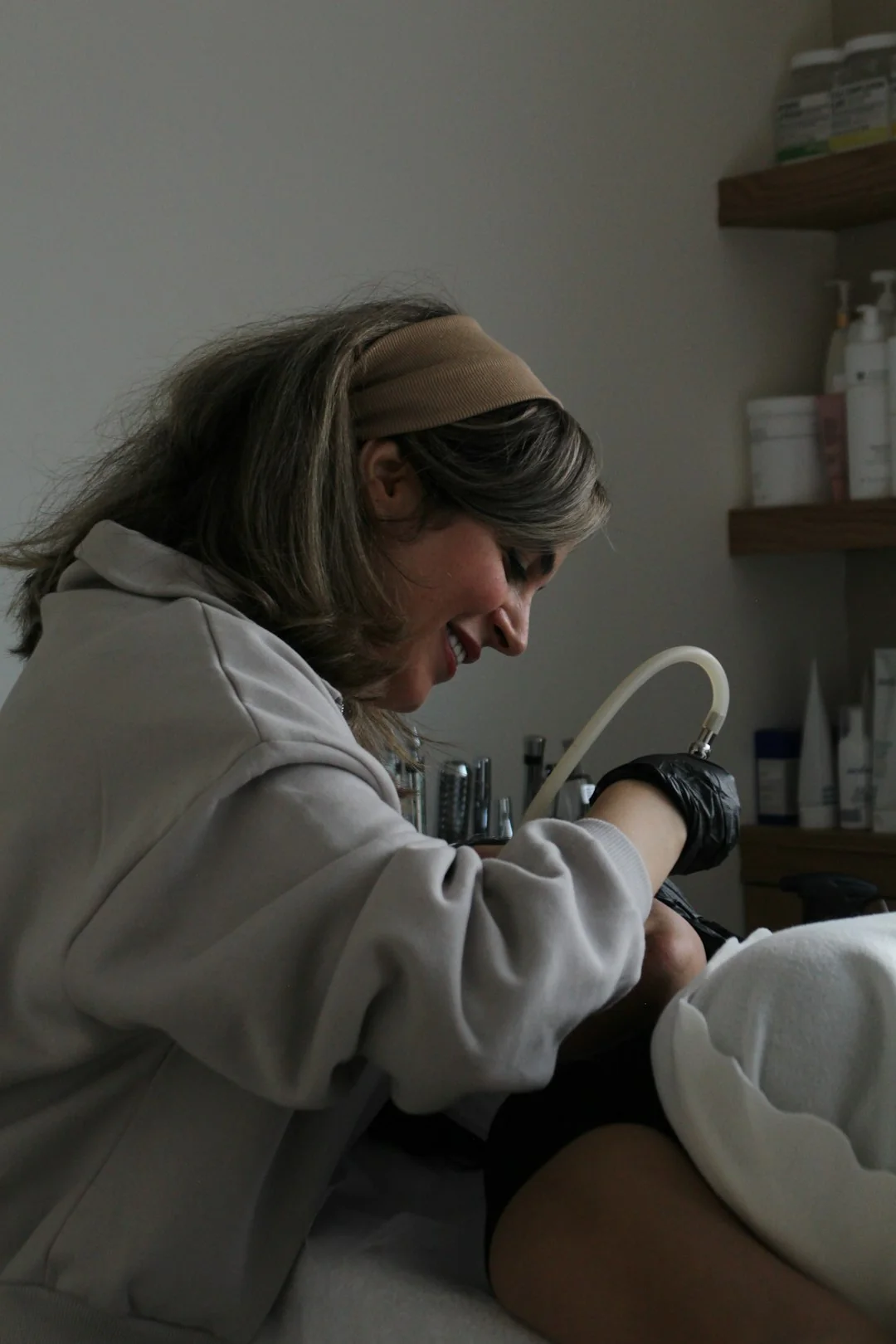 Cleaner using a vacuum in a stylish indoor setting, showcasing cleaning equipment and techniques.